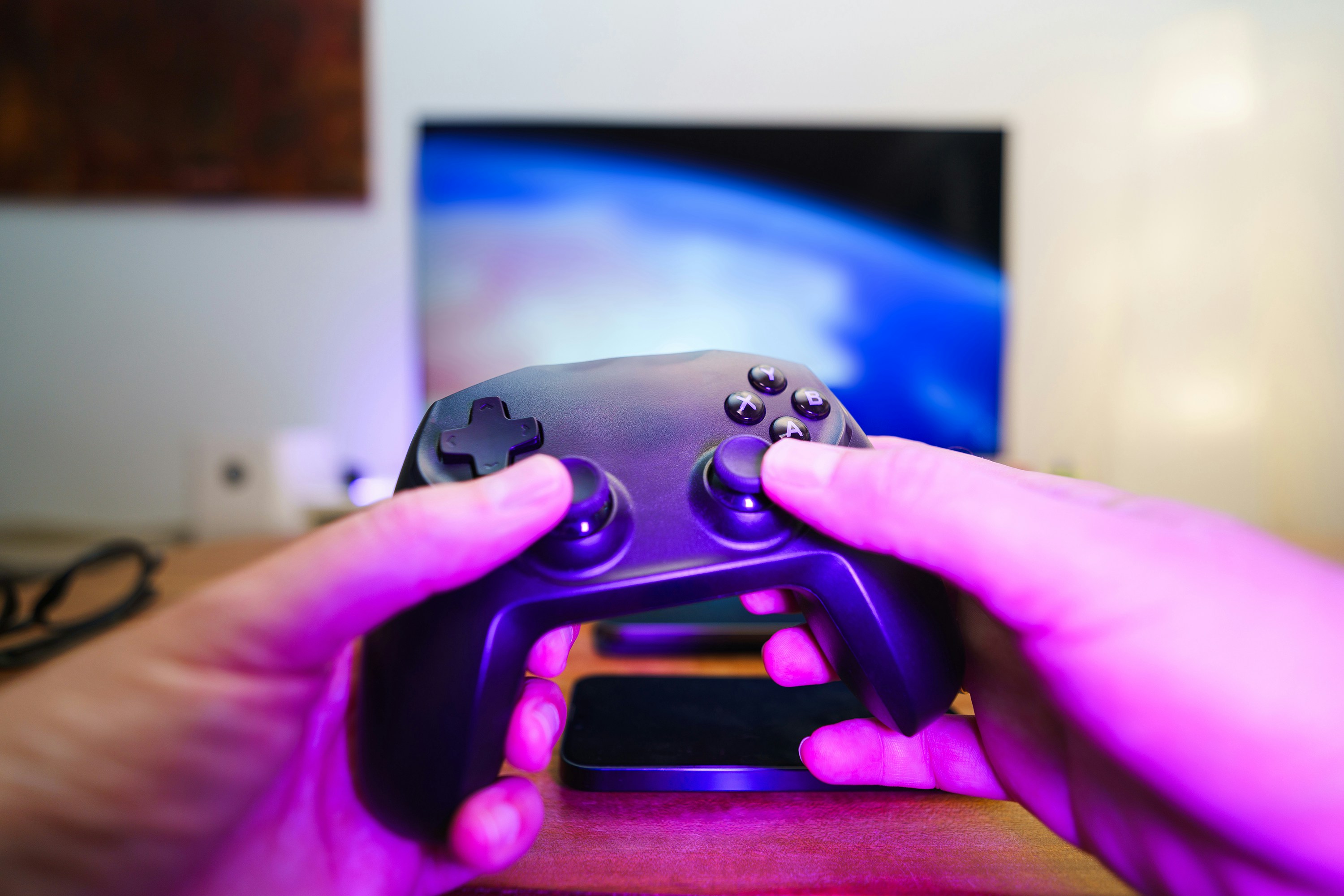 Controller lit by magenta ambient light