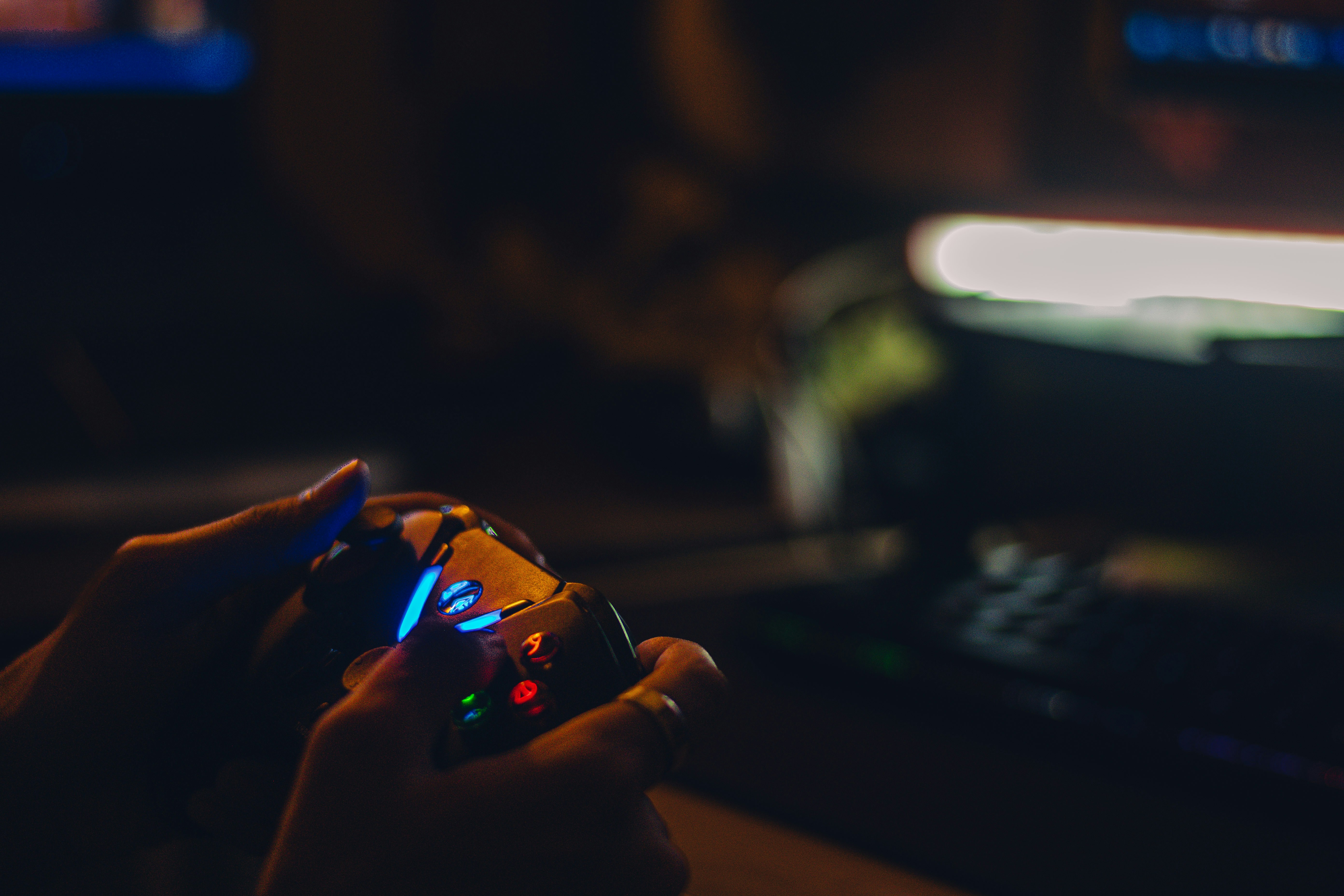 PlayStation controller in a dark gaming room